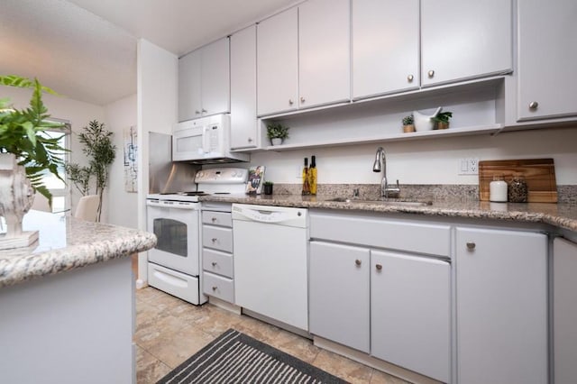 kitchen with white cabinets, white appliances, and sink