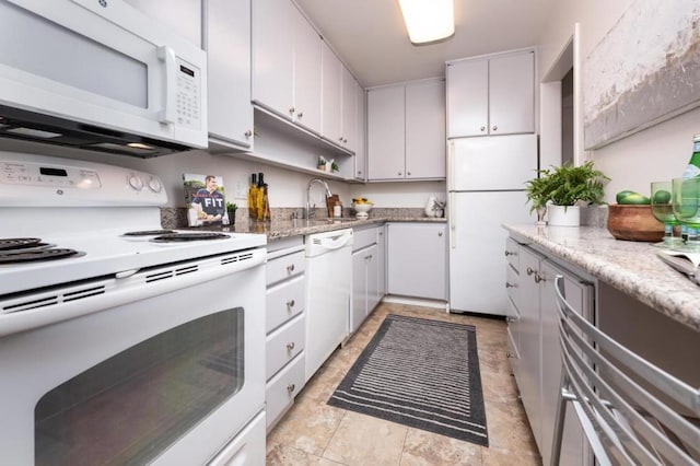 kitchen with white cabinetry, white appliances, and sink