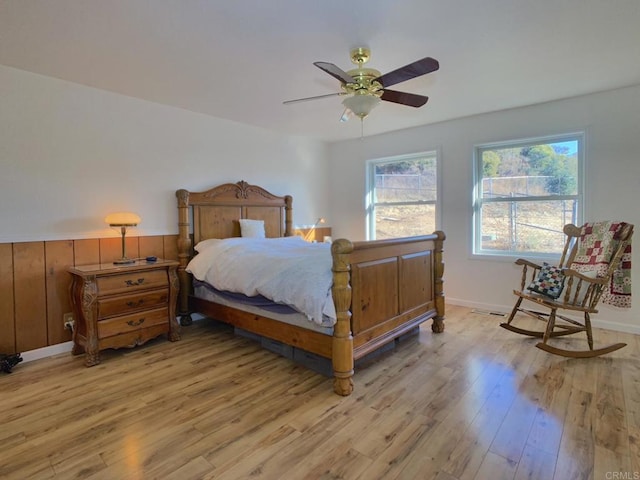 bedroom with light wood-type flooring and ceiling fan