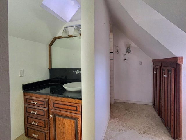 bathroom with vanity and lofted ceiling