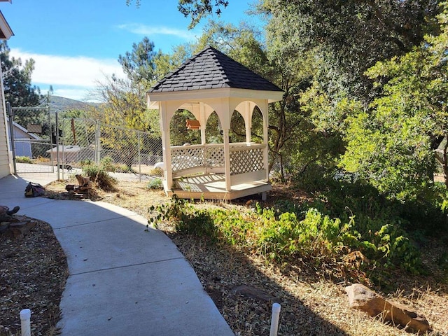 surrounding community with a gazebo and a mountain view