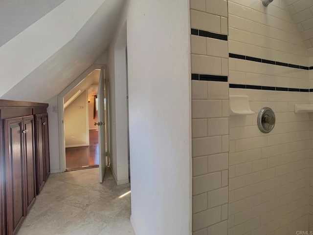 hallway featuring vaulted ceiling and light wood-type flooring