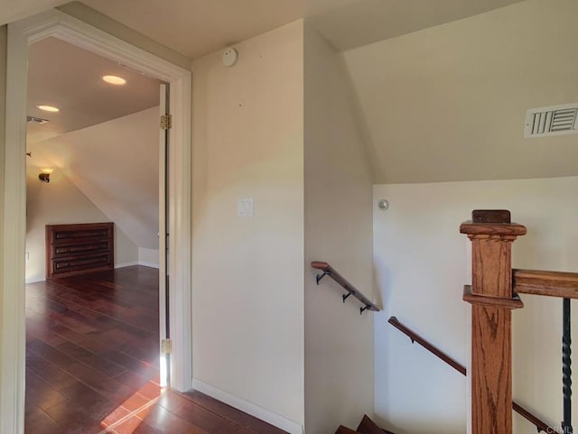 stairway with lofted ceiling and wood-type flooring