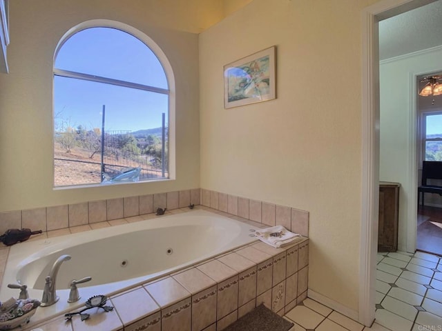 bathroom with tile patterned floors and a relaxing tiled tub