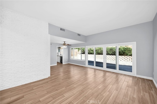 unfurnished living room featuring ceiling fan and light wood-type flooring