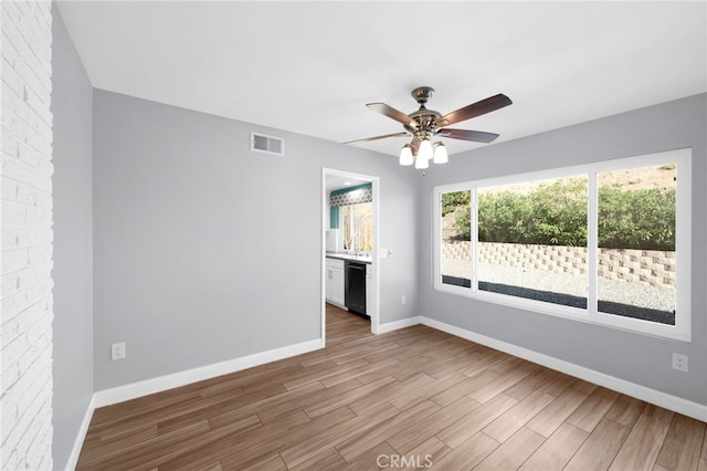 empty room with light hardwood / wood-style floors and ceiling fan