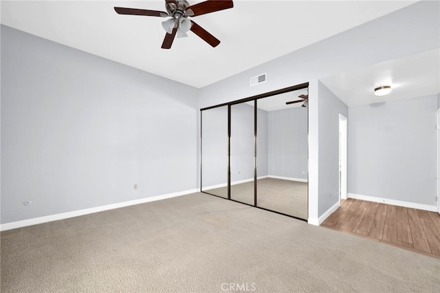 unfurnished bedroom featuring carpet floors, a closet, and ceiling fan