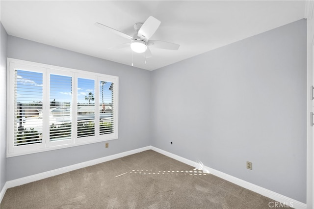 carpeted empty room featuring ceiling fan