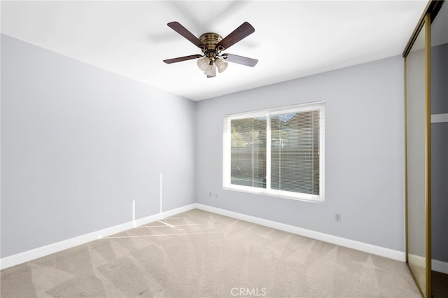 interior space with ceiling fan and light carpet