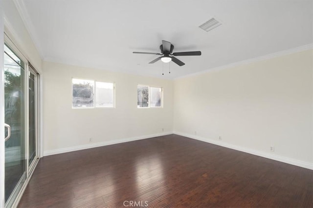 empty room featuring crown molding, ceiling fan, and dark wood-type flooring