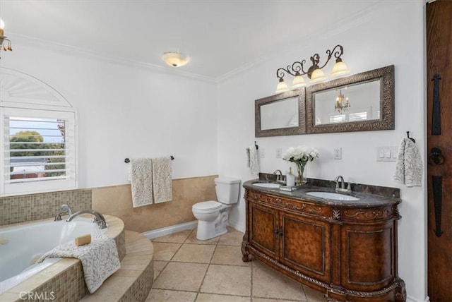 bathroom featuring tiled bath, toilet, vanity, and ornamental molding