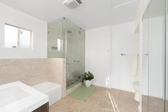 full bathroom featuring plus walk in shower, vanity, toilet, and tile patterned flooring