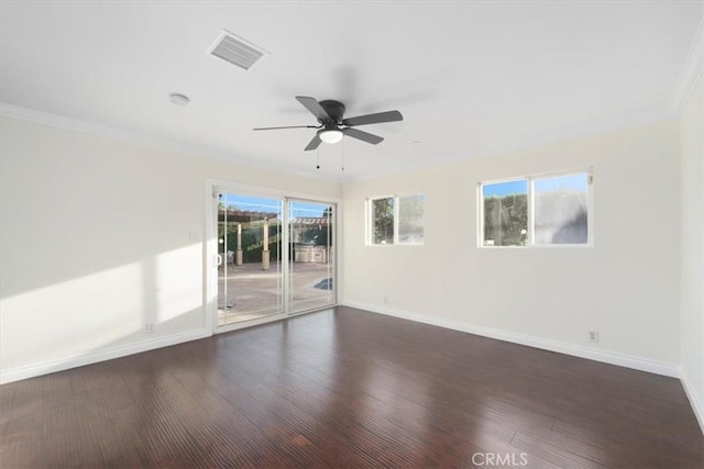 spare room with ornamental molding, ceiling fan, and dark wood-type flooring