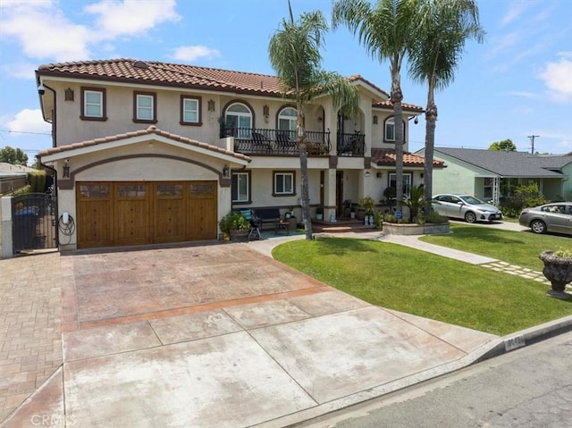 mediterranean / spanish-style home with a front yard, a balcony, and a garage