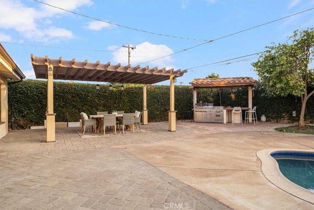 view of patio / terrace with a pergola, exterior bar, exterior kitchen, and a fenced in pool