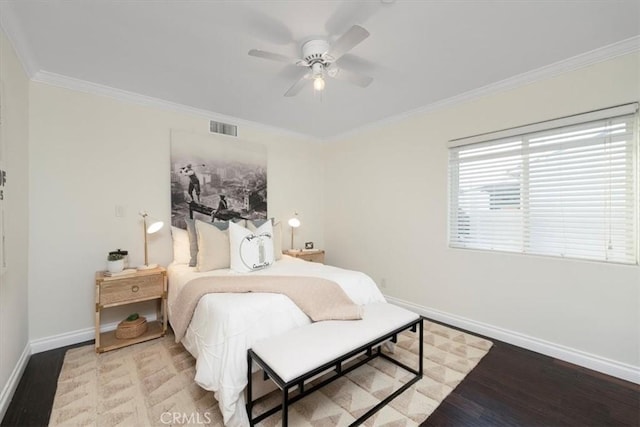 bedroom featuring ceiling fan, crown molding, and hardwood / wood-style flooring