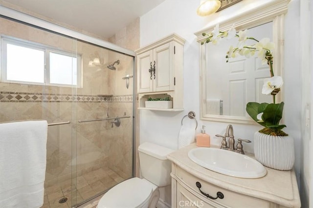 bathroom featuring vanity, toilet, and walk in shower