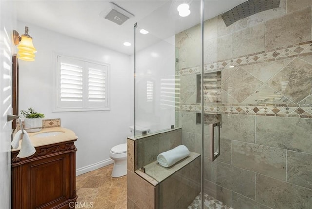 bathroom featuring vanity, toilet, and an enclosed shower