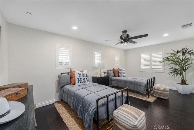 bedroom featuring multiple windows, ceiling fan, and dark hardwood / wood-style flooring