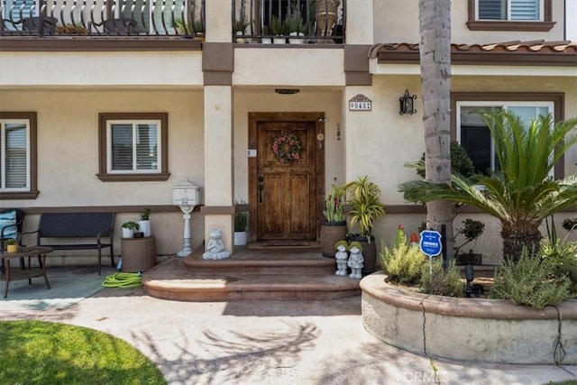 entrance to property with a patio area and a balcony