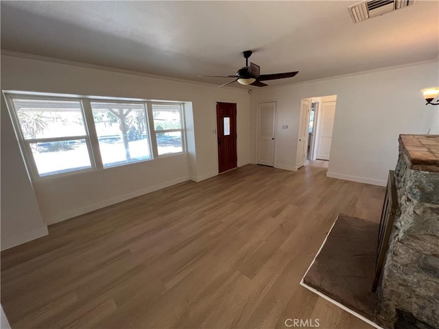 unfurnished living room featuring light wood-type flooring, ceiling fan, and ornamental molding