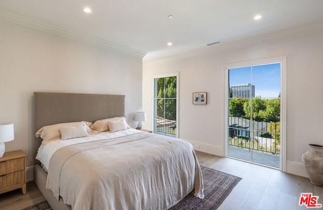 bedroom featuring ornamental molding, access to outside, and light hardwood / wood-style flooring