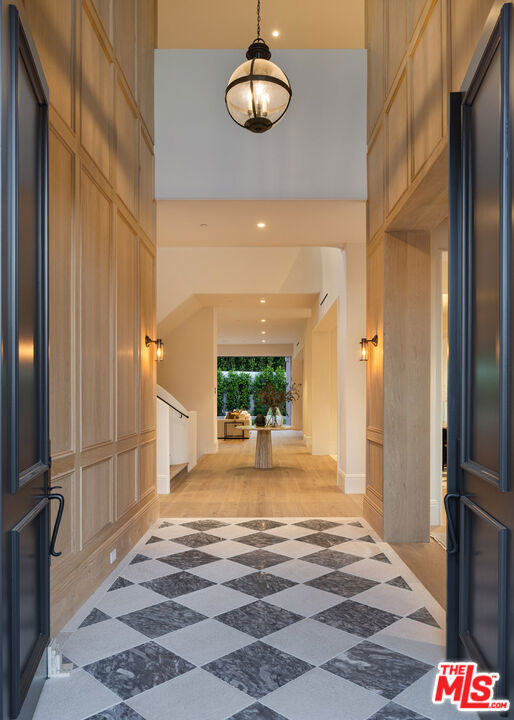 entrance foyer featuring wood-type flooring and a high ceiling