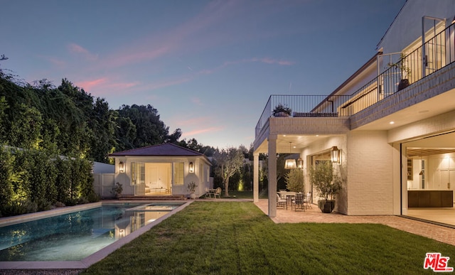 exterior space featuring a patio area and a lawn