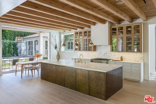 kitchen featuring a center island with sink, white cabinetry, wooden ceiling, and light hardwood / wood-style flooring