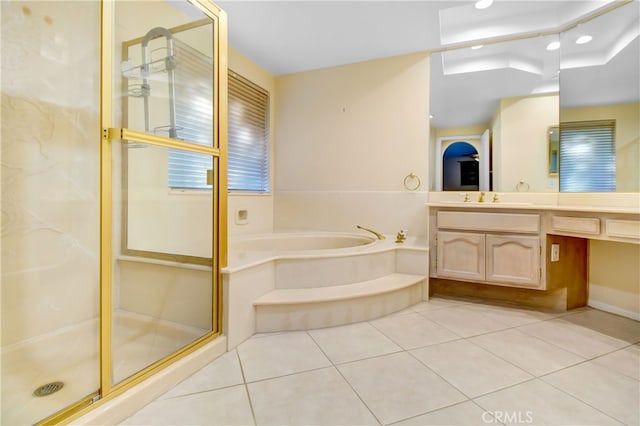 bathroom featuring tile patterned flooring, vanity, and plus walk in shower