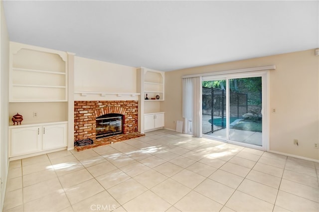 unfurnished living room featuring built in features, light tile patterned floors, and a fireplace