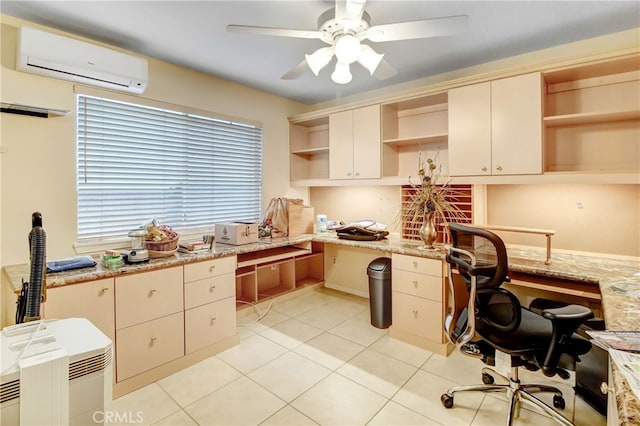 home office with light tile patterned floors, built in desk, a wall unit AC, and ceiling fan