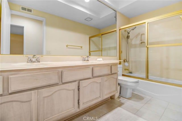 full bathroom with shower / bath combination with glass door, vanity, tile patterned floors, and toilet