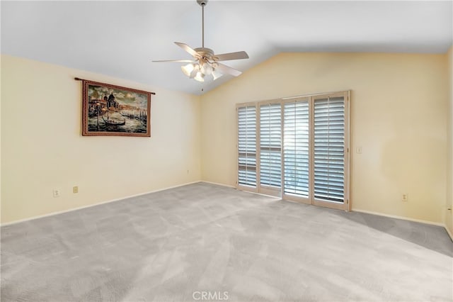 unfurnished room featuring ceiling fan, light colored carpet, and lofted ceiling