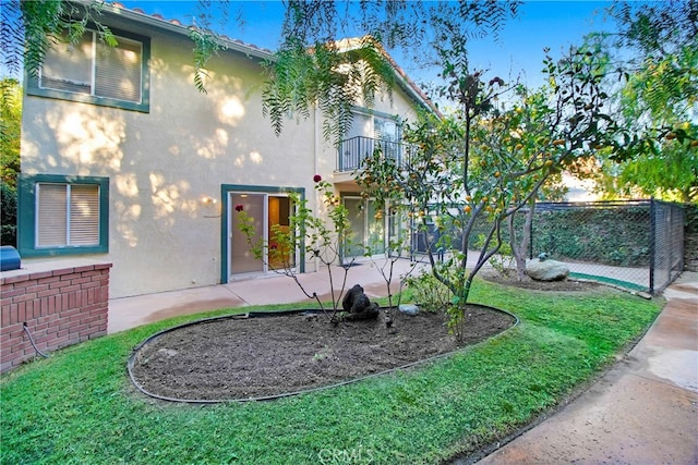 view of yard featuring a balcony and a patio