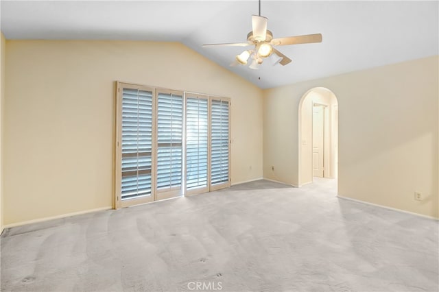 carpeted spare room featuring ceiling fan and vaulted ceiling