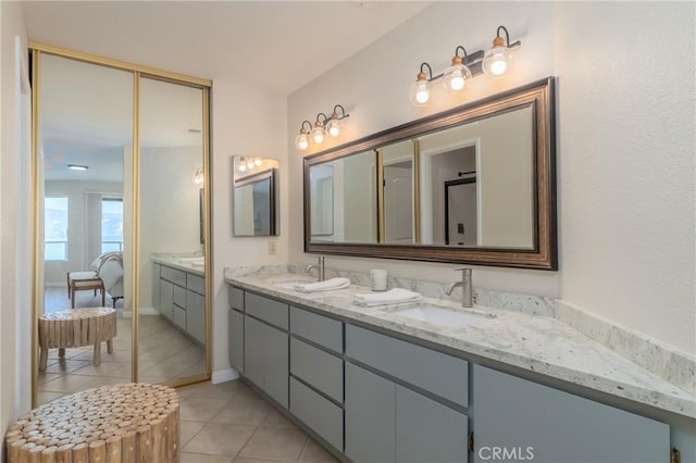 bathroom with tile patterned flooring and vanity