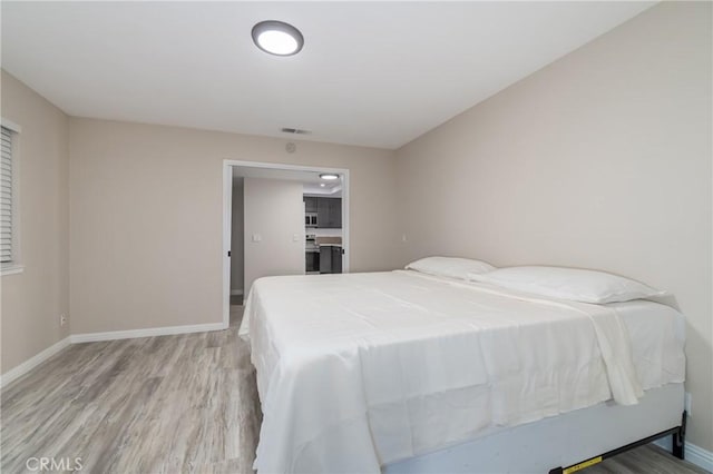 bedroom with light wood-type flooring