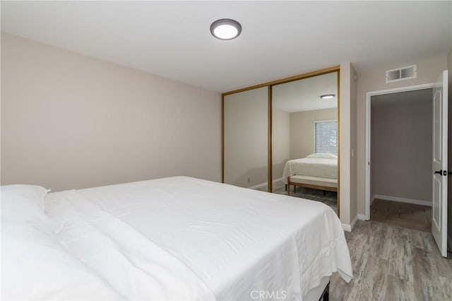 bedroom featuring hardwood / wood-style flooring and a closet