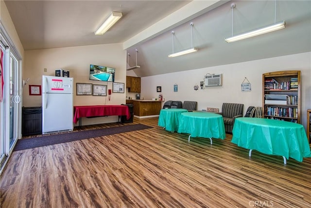 interior space featuring a wall unit AC, beamed ceiling, high vaulted ceiling, and hardwood / wood-style flooring