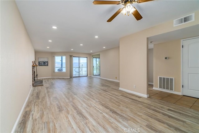 unfurnished living room featuring light hardwood / wood-style floors and ceiling fan