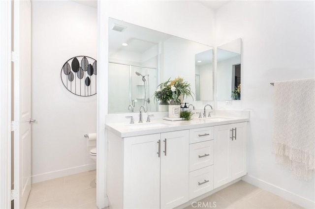 bathroom featuring tile patterned flooring, vanity, a shower with shower door, and toilet