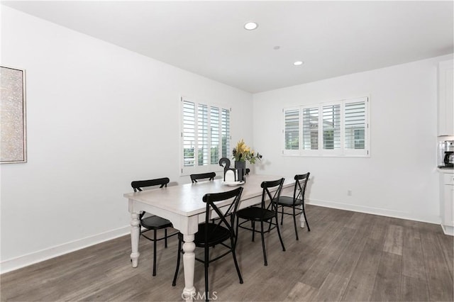 dining area featuring dark wood-type flooring