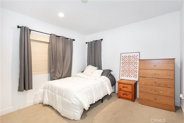 bedroom featuring light colored carpet