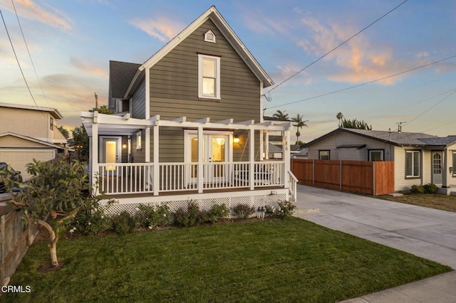 front of property with a lawn, a pergola, and a porch