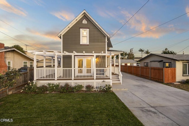 view of front of home with covered porch and a lawn