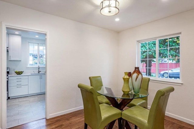 dining space with sink, a wealth of natural light, and hardwood / wood-style floors