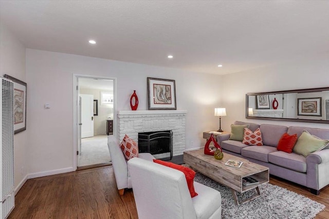 living room with a fireplace and dark hardwood / wood-style flooring