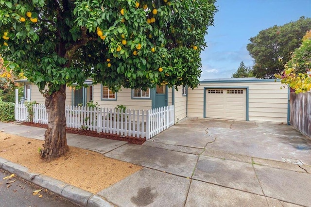 view of property hidden behind natural elements featuring a garage