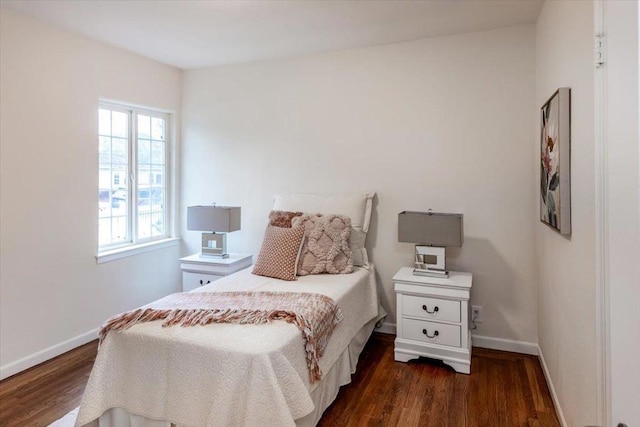 bedroom with dark hardwood / wood-style floors